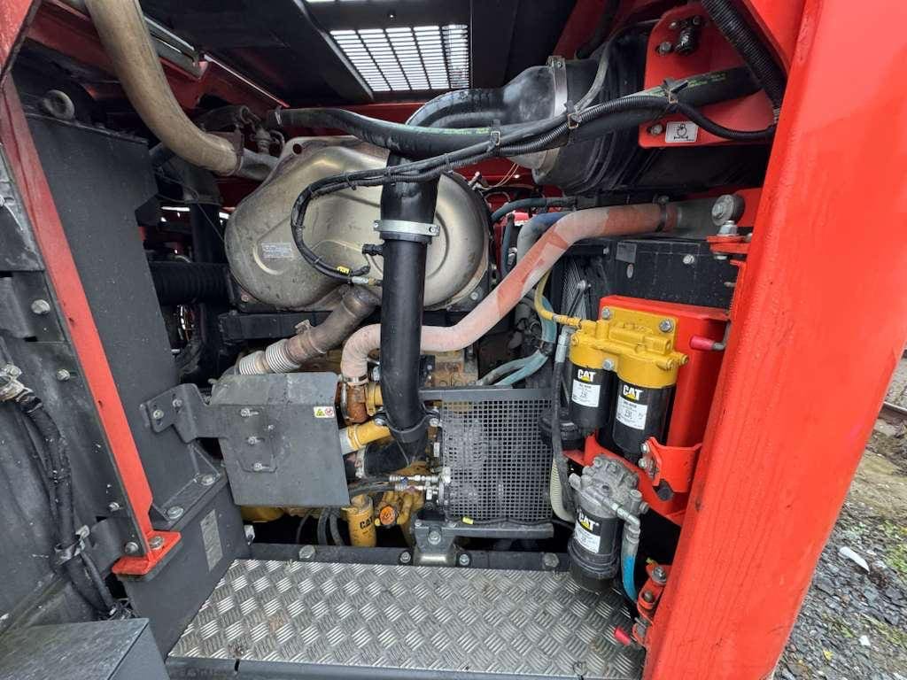 Red heavy-equipment engine compartment with CAT filters
