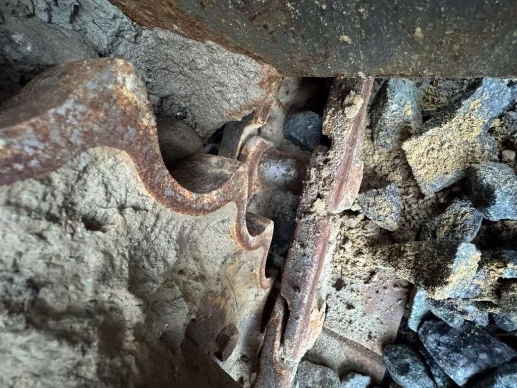 Rusty saw blade teeth amid rubble