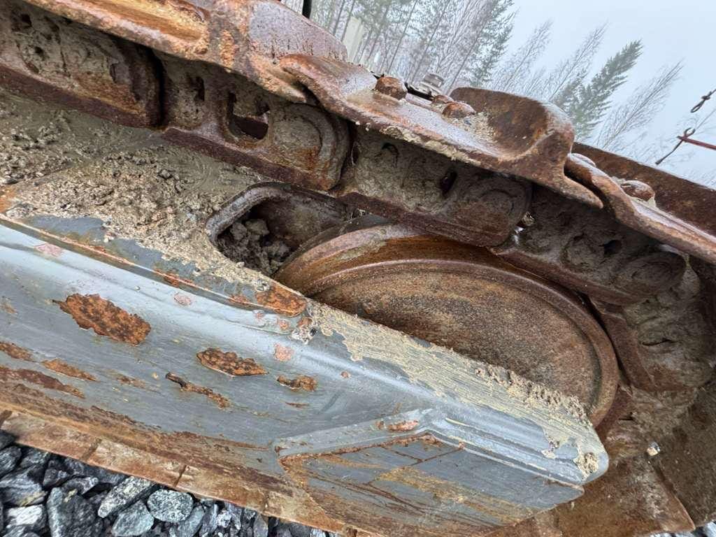 Rusty excavator track and sprocket close-up