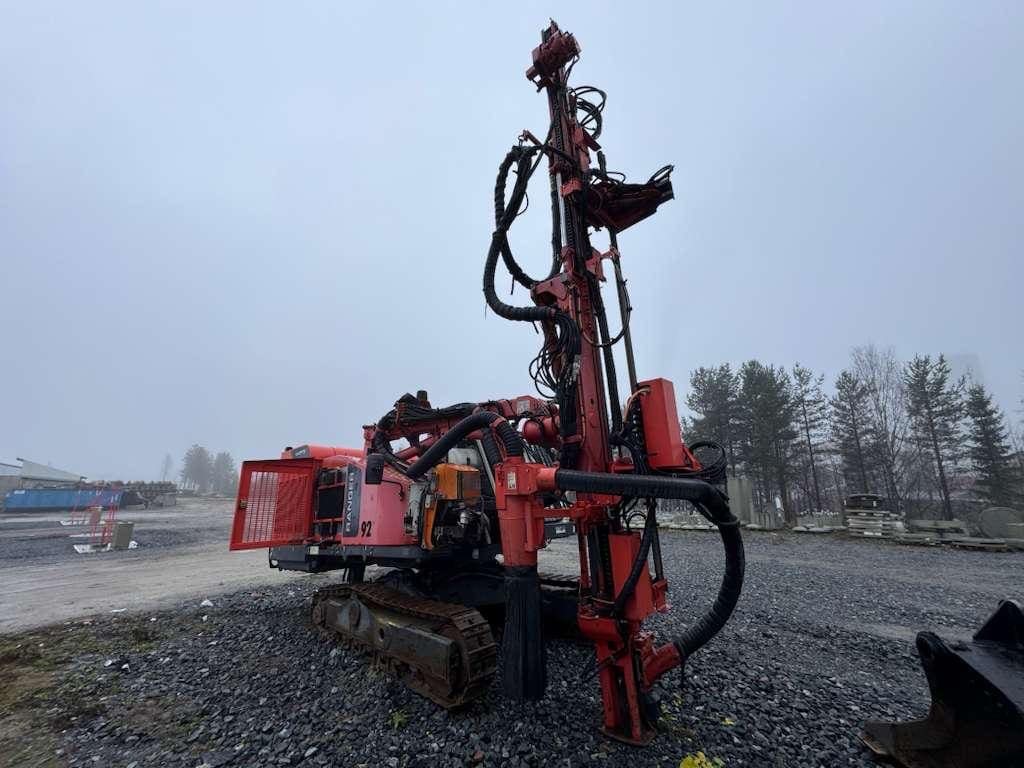 red crawler drill rig at construction site