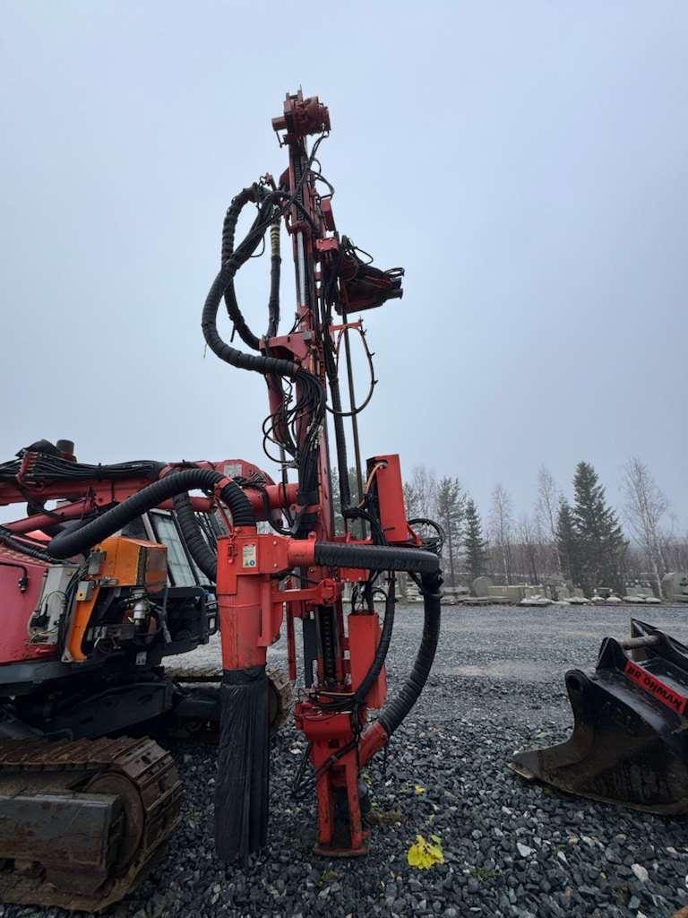 Red hydraulic drilling rig on excavator tracks