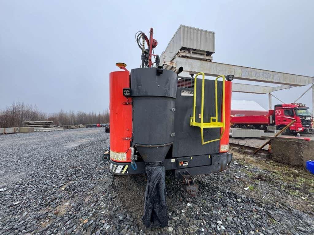 Red and black industrial mixing machine with ladder