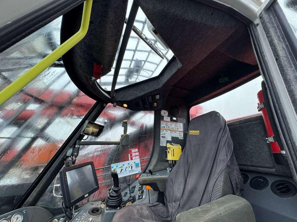 Rain-speckled heavy equipment cab with joystick