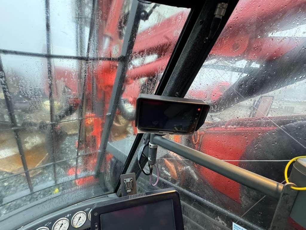 Wet construction equipment cab interior with monitors
