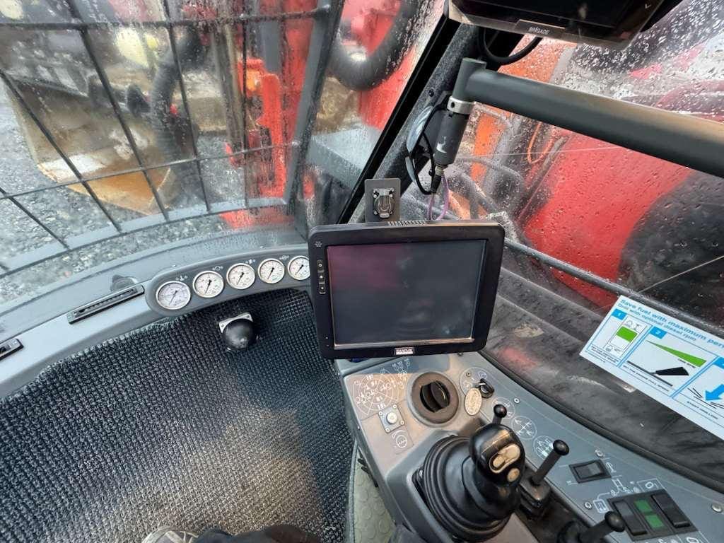 Construction vehicle cab with joystick and monitor