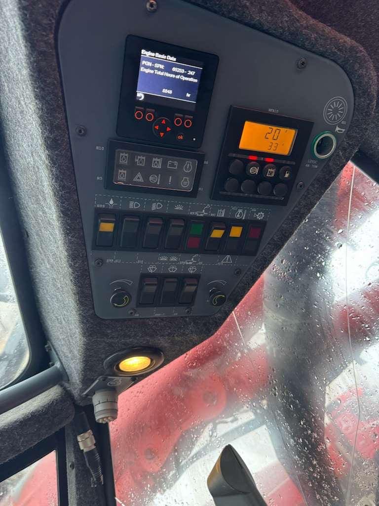 Tractor cab overhead control panel with raindrops