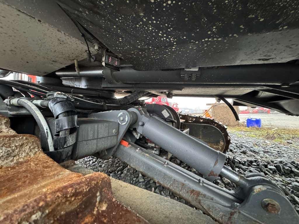 Close-up of excavator undercarriage hydraulics